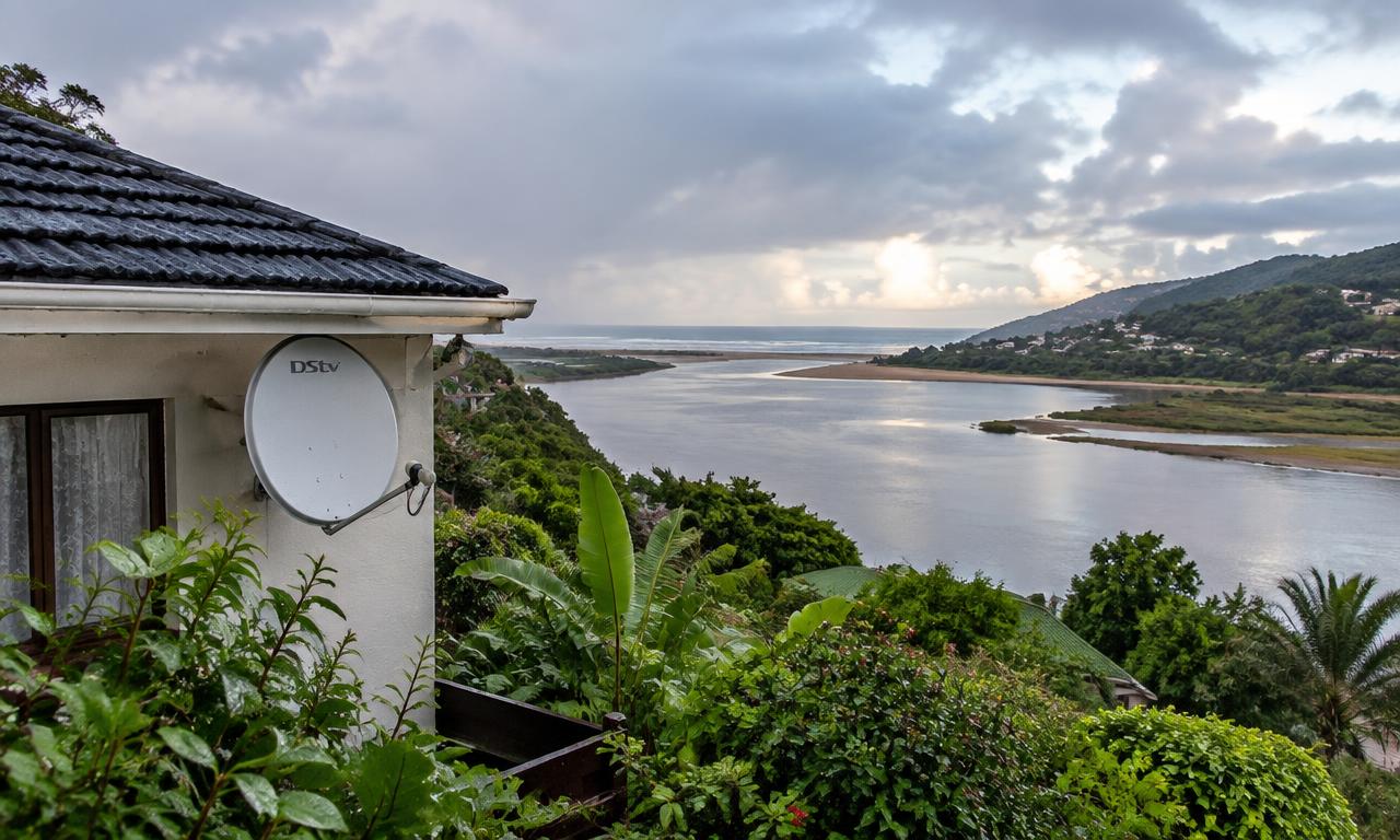 DSTV dish on a house above the Great Brak River estuary after rain