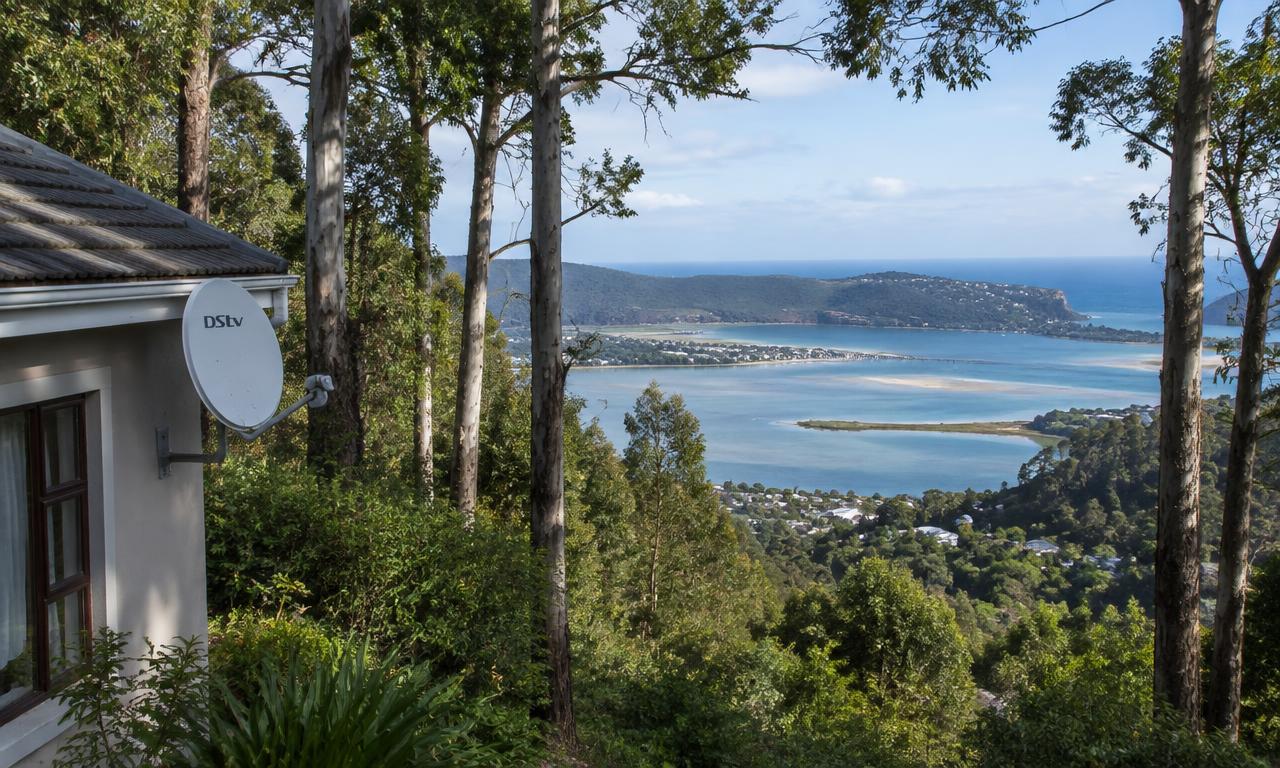Satellite dish on a Knysna home among tall trees overlooking the lagoon